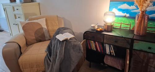 a living room with a couch and a book shelf at Séjournez avec le Mont-Saint-Michel en toile de fond 8 pers in Huisnes-sur-Mer