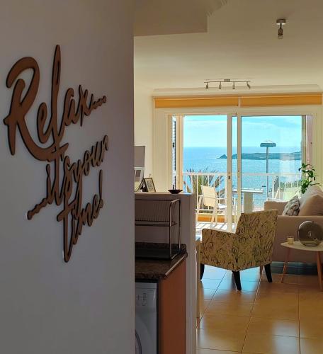 a kitchen and living room with a view of the ocean at Casa Poris in Poris de Abona