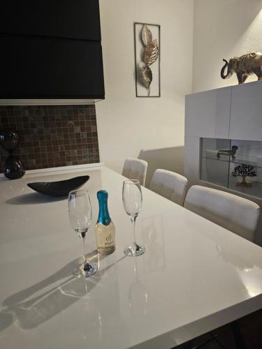 two wine glasses sitting on a kitchen counter at Blu Petrolio Stay-Karabas Apartments in Vicenza