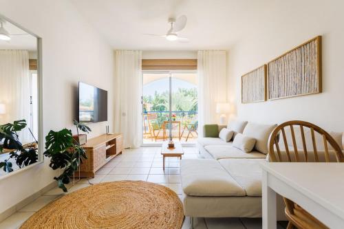 a living room with a couch and a table at Mediterranean Dream by the Sea in Paphos City