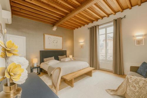 a bedroom with a bed and a large window at Maunoury Citybreak in Chartres