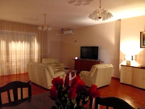 a living room with two chairs and a television at House Revolution Style FC in Oliveto Citra