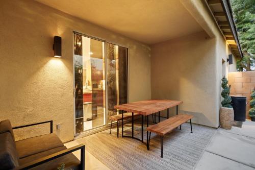 a patio with a wooden table and benches at Walk to the Festivals - Private Pool & Spa in Indio