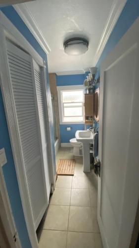 a bathroom with a white toilet and a window at The Shire in Oakland