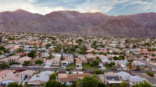 an aerial view of a small town in front of mountains at Desert Paradise Retreat - Pool Hot Tub & Fire Pit in La Quinta