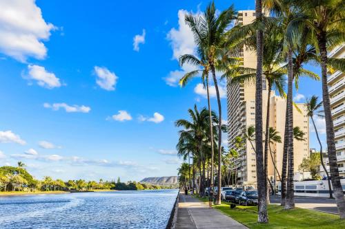 a view of a river with palm trees and buildings at Wyndham Vacation Resorts Royal Garden at Waikiki in Honolulu