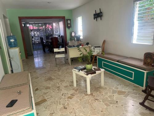a living room with a couch and a table at Thegreenhouse in Santiago de los Caballeros