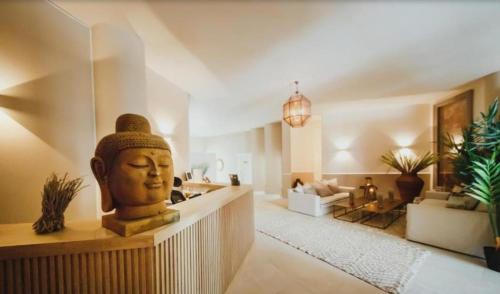 a living room with a large statue of a head at THE PALMiA I iskele I Trikomo in Aglantzia