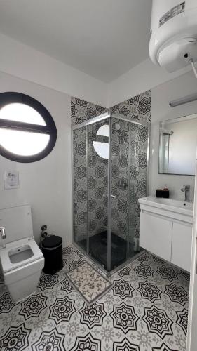 a bathroom with a shower and a toilet and a sink at THE PALMiA I iskele I Trikomo in Aglantzia