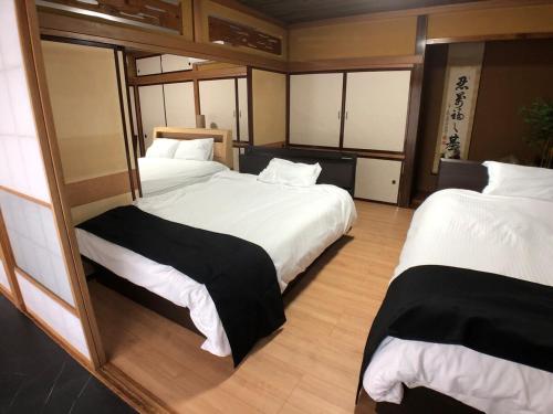 Postel nebo postele na pokoji v ubytování OZ nikko