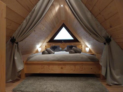a bedroom with a canopy bed with a window at Domki Na Brzyzku in Zakopane