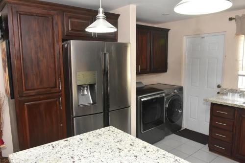 a kitchen with a stainless steel refrigerator and a dishwasher at Jevico's Cozy Villa in Priory