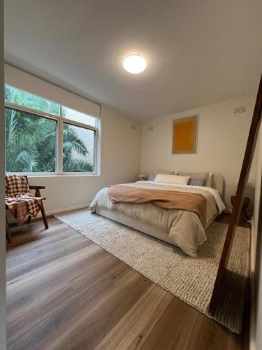 a bedroom with a bed and a large window at Fulton Flow Resort Apartment in Melbourne