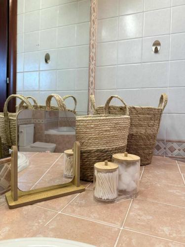 a bathroom with a mirror and baskets on the floor at Casa Verde Trikala in Tríkala
