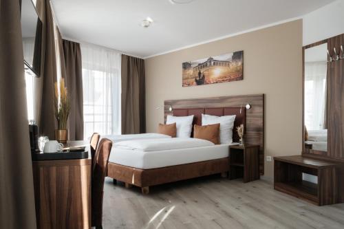 a hotel room with a bed and a mirror at The sQuare Hotel in Frankfurt/Main