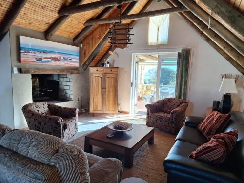 a living room with couches and a coffee table at See-Rus Self Catering Seaside Accommodation in Jacobs Bay