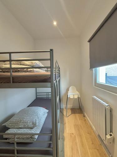 a room with two bunk beds and a window at L'Appartement du Port in Étaples