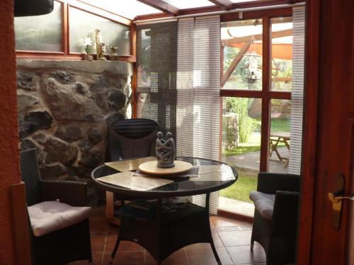 a dining room with a table and a stone wall at Apartments České Středohoří in Teplice