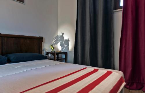 1 dormitorio con 1 cama con cortina roja en La Limonaia en Pollutri