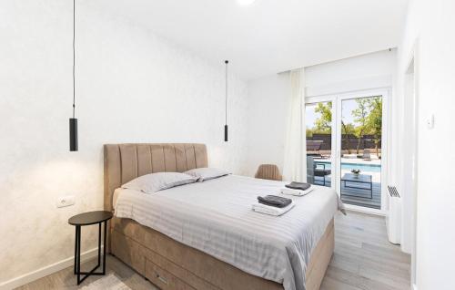 a bedroom with a bed and a view of a pool at Villa Vanja in Imotski