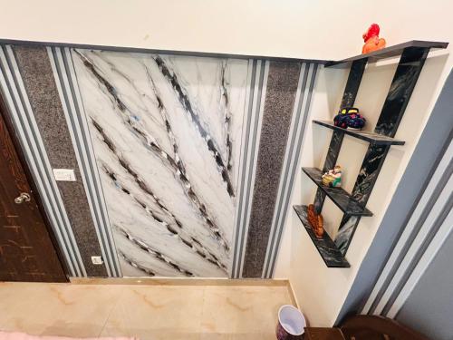 a room with two shelves on the wall at Fare Home Apartment in Karachi