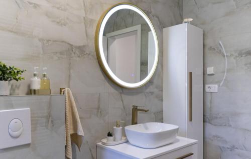 a bathroom with a white sink and a mirror at Villa Vanja in Imotski