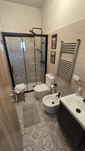 a bathroom with a shower and a toilet and a sink at Finestra su Lago in Genzano di Roma