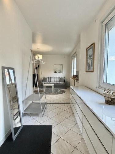 a living room with a ladder in the middle of a room at Le Nid du Port in Étaples