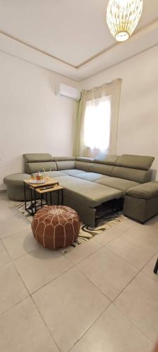 a living room with a couch and a table at Appartement a 10 min de l aeroport de marrakech in Marrakech