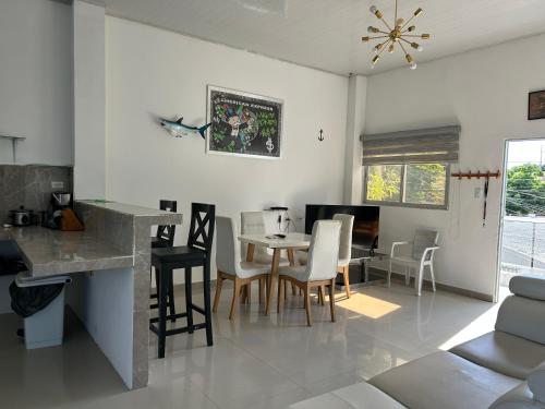 a kitchen and living room with a table and chairs at ALTAVITA apart completo a 100 m del mar in Puerto Colombia