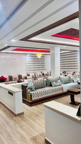 a living room with couches and a table at Ferme royale Bensliman in Ben Slimane