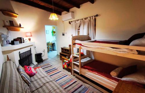 a bedroom with two bunk beds and a living room at AsteriA 3D House Inn in Pano Arodes