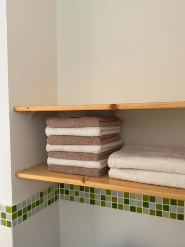 a stack of towels on a shelf in a bathroom at Ubytovanie 31 in Rajecké Teplice