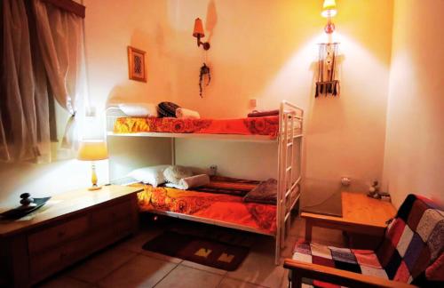 a bedroom with two bunk beds and a desk at AsteriA 3D House Inn in Pano Arodes