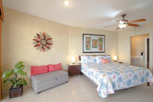 a bedroom with a bed and a couch and a fan at Sonoran Spa W608 in Campo del Medio