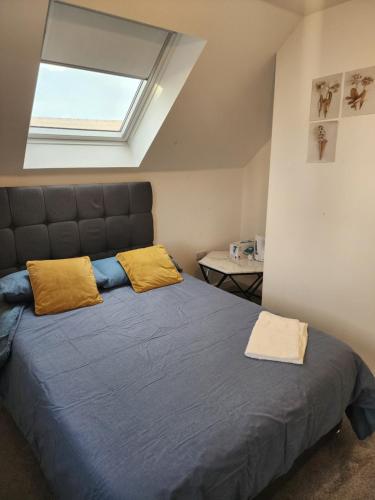 a bedroom with a large bed with yellow pillows at Trinity Apartment in Highbridge