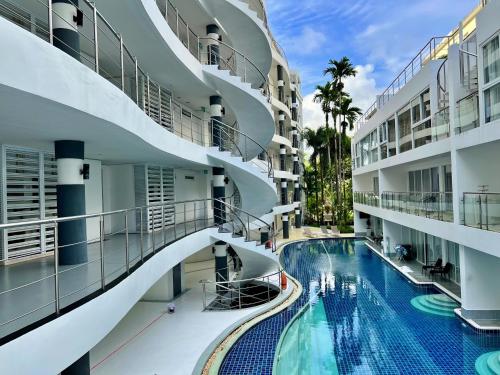 an image of a swimming pool in a building at Sunset Plaza by RESAVA in Karon Beach
