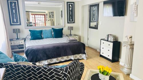 a bedroom with a bed and a couch at Artzy's Studio - 1km to Olivedale Clinic in Northriding