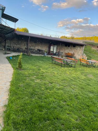 a building with picnic tables in a field of grass at Sveta Voda in Kriva Palanka
