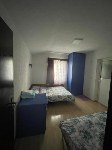 a room with two beds and a table in it at Sveta Voda in Kriva Palanka