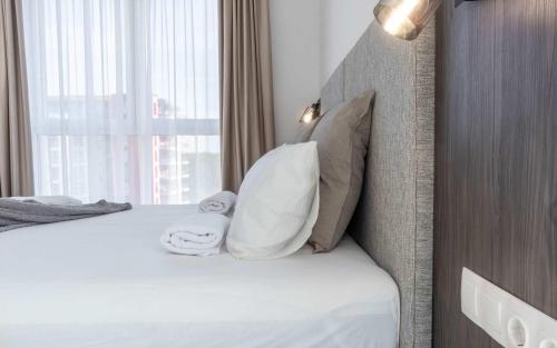 a hotel room with a bed with two towels at Joy City Stay Forest 54-85 in Dumbrăviţa