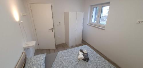 a room with a pair of shoes sitting on a rug at AiM in Kukljica