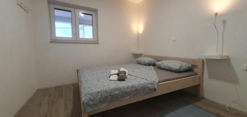 a bedroom with a bed with two stuffed animals on it at AiM in Kukljica