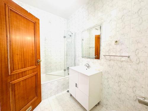 a bathroom with a sink and a mirror at ApuliaMar Apartment in Apúlia