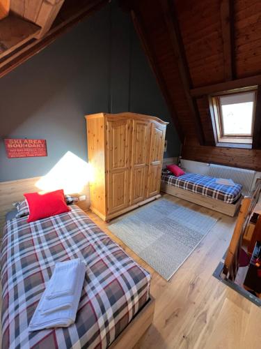 an attic room with two beds and a lamp at Melodia del bosco in Tarvisio