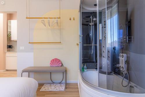 a bathroom with a shower and a stool in a room at Venus Suite - Romantic Private Spa - Centro Livorno in Livorno