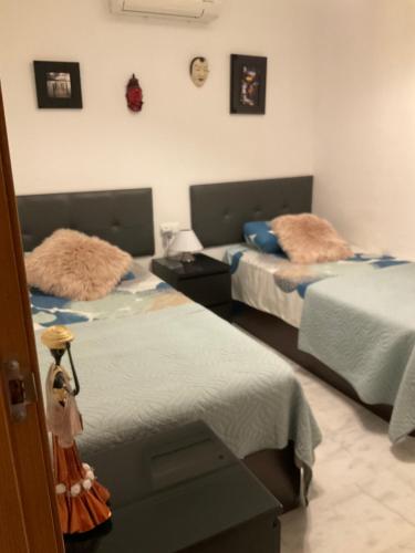 two beds in a room with two beds sidx sidx sidx at Casa de Nio in Algorfa
