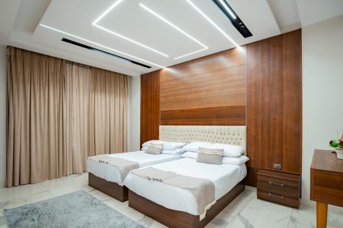 a bedroom with a large bed and a television at My Villa Hotel in Sheikh Zayed