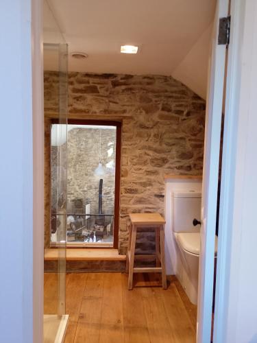 a bathroom with a window and a sink and a toilet at Barn Retreat with Mountain Views in Athy