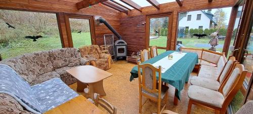 a living room with a couch and a table and a stove at Horská chaloupka Bělá pod Pradědem in Bělá pod Pradědem